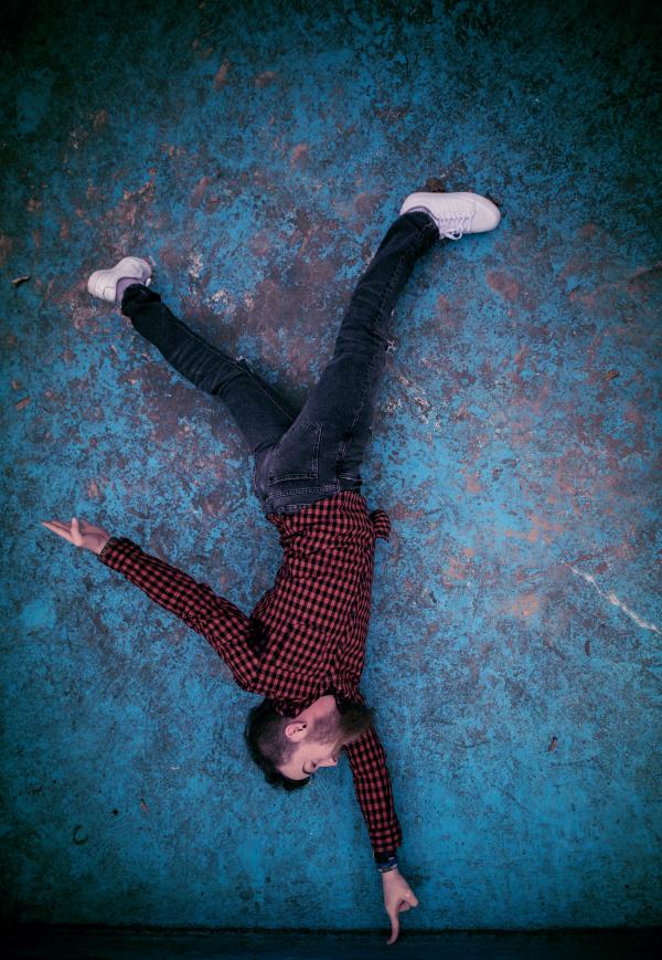 Man Standing on Finger Photo