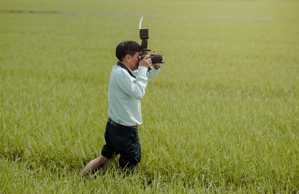 Man Taking Photos in the Field