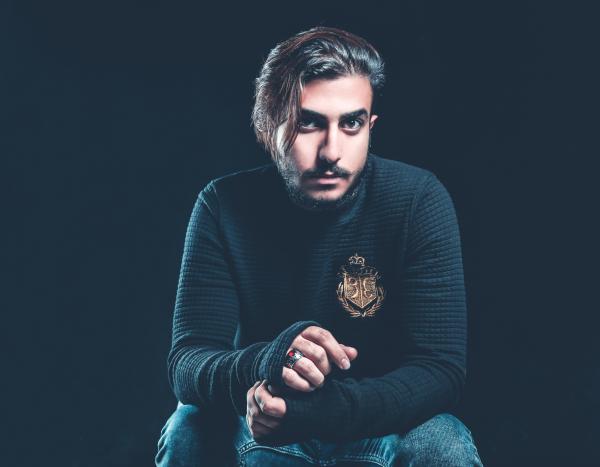 Man Wearing Black Sweater Holding His Hand