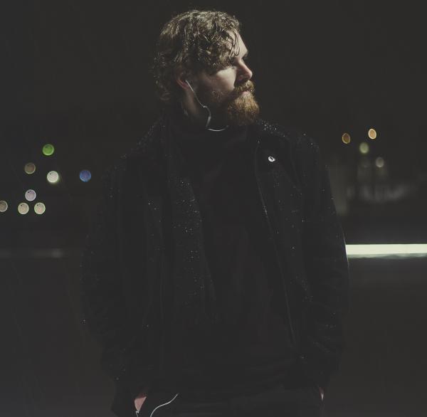 Man Wearing Black Zip-up Jacket Taking Picture during Nighttime