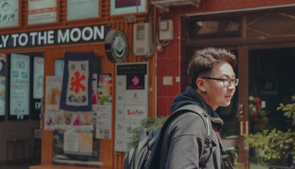 Man With Eyeglasses Wearing Black Hoodie and Black Backpack