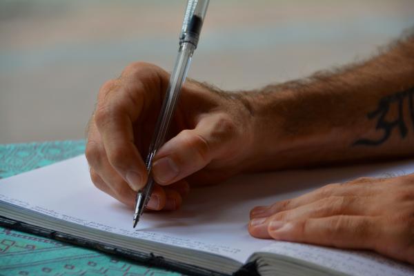 Man Writing in a Book