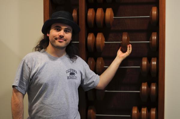 Me moving bead on large abacus - facing camera - closeup