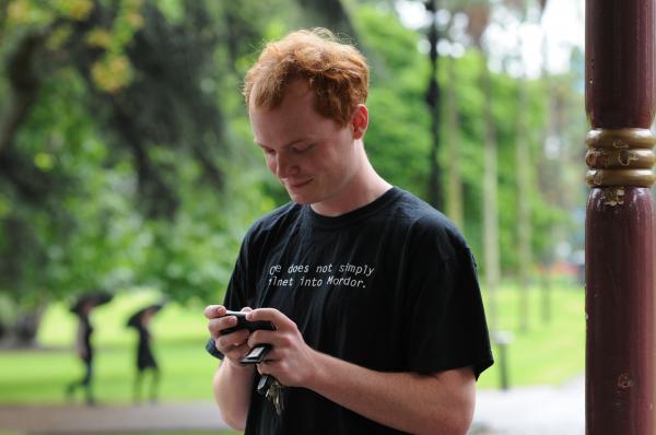 Meetup attendee using phone