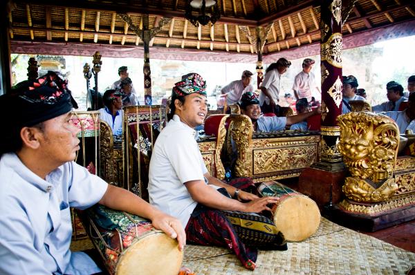 Men play traditional gamelan percussion