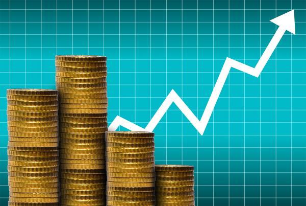 Money in a pile of coins with financial graph
