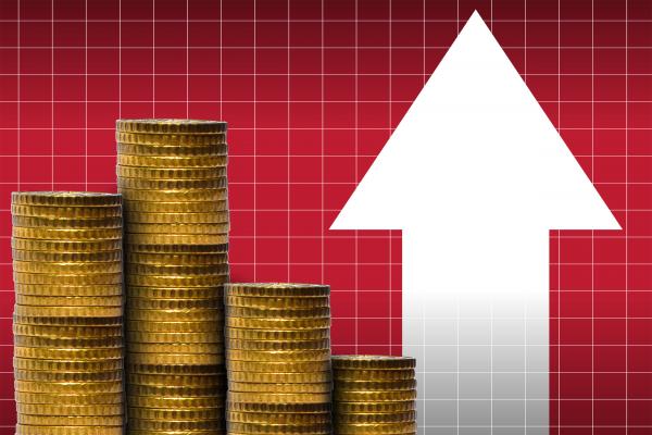 Money in a pile of coins with financial graph