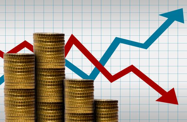 Money in a pile of coins with financial graph