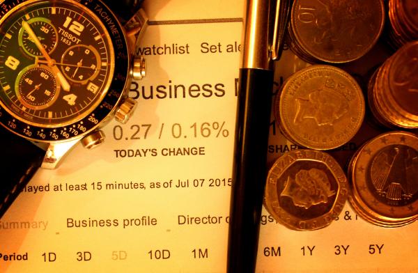Money with pen and watch