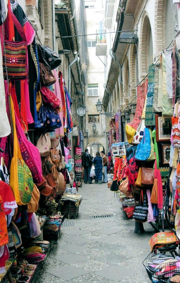 Narrow market street with shops and stan