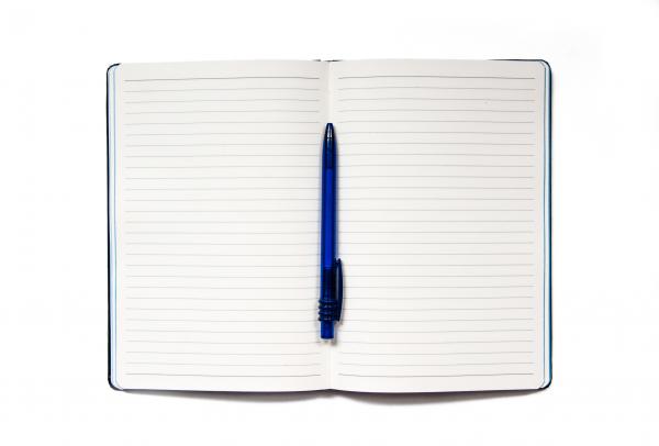 Notebook with pen isolated on white