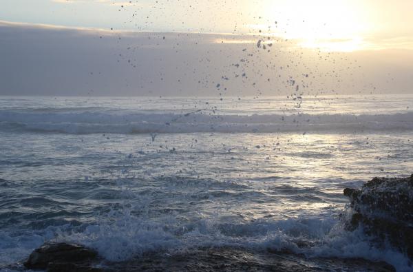 Ocean Waves Hammering Rock Boulder