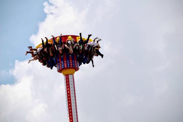 People Riding on White and Red Carnival Rides