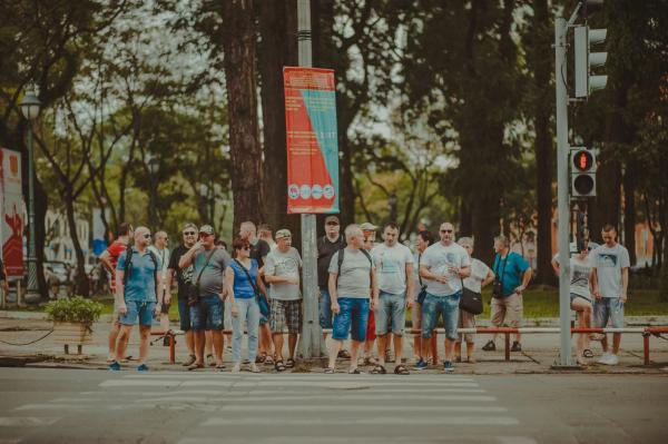 People Standing Near Metal Traffic Post