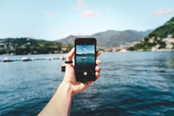 Person Holding Space Gray Iphone 5s Taking Picture of Beach