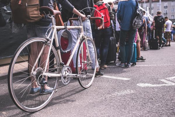 Person in Black Sweater Hold a Grey Road Bike