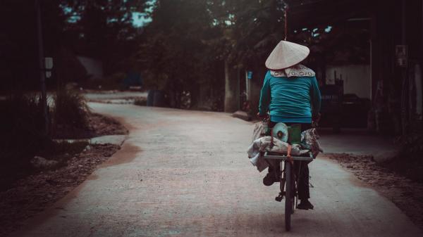 Person in Blue Long-sleeves Riding Bicycle