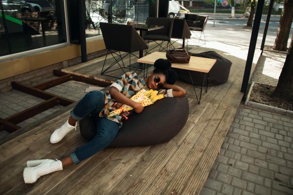 Person Lying on Bean Bag Chair