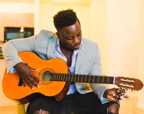Person Playing Guitar