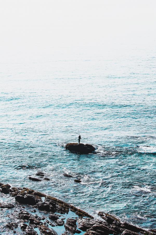 Person Standing on Rock Formation