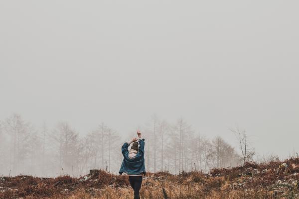 Person Wearing Blue Jacket on Field