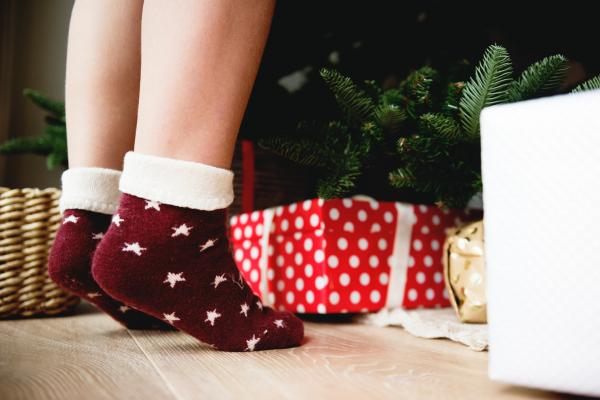 Person Wearing Pair of Maroon Star Printed Socks