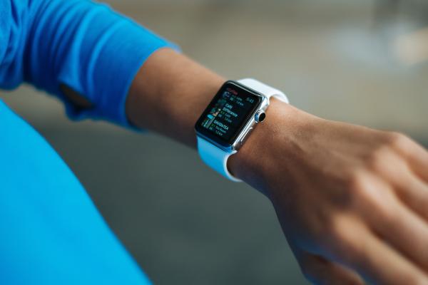 Person Wearing White Silicone Strap Black Smart Watch