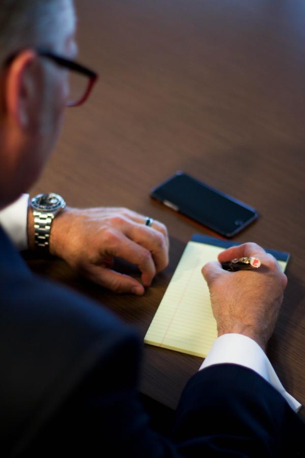 Person Writing Notes on White Ruled Paper