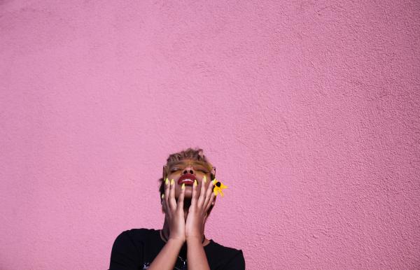 Photo of a Woman Leaning on Wall