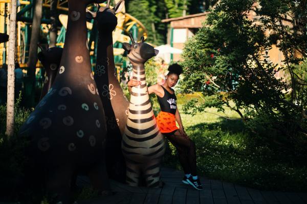 Photo of Woman Sitting on Zebra Statue