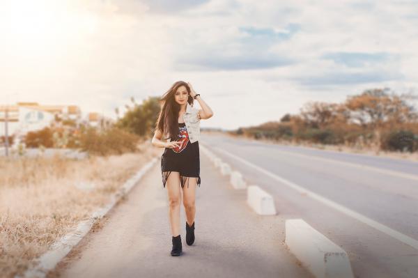 Photography of a Woman Walking on Pavement