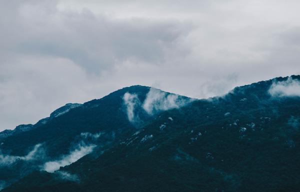 Photography of Mountain Under Cloudy Sky