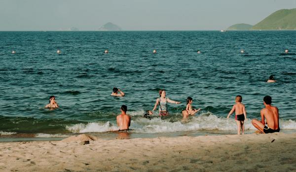 Photography of People Swimming In The Sea