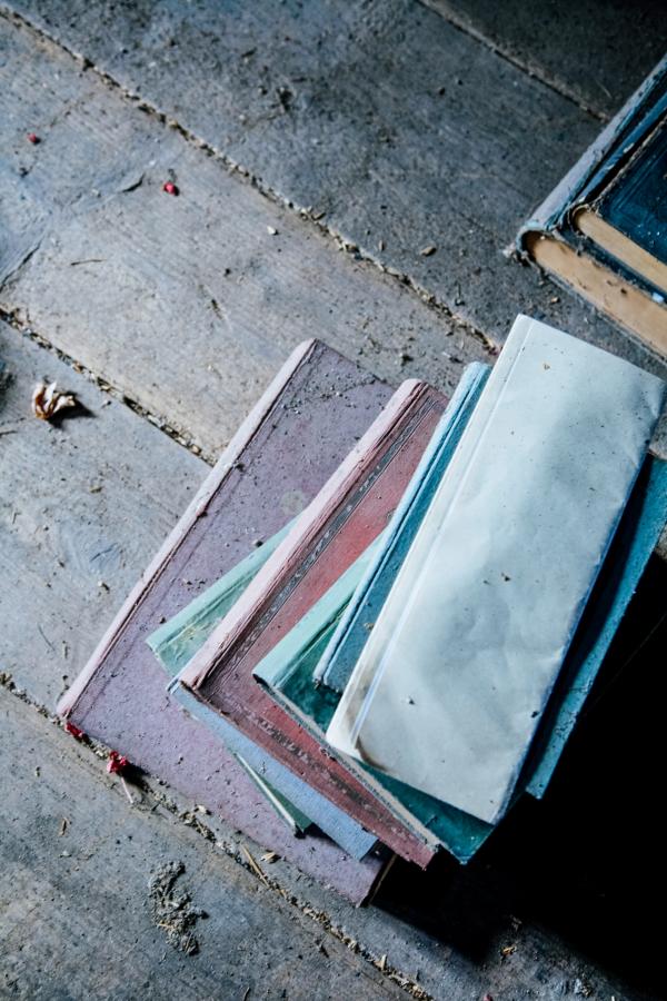 Pile of Books on Brown Wooden Surface during Daytime
