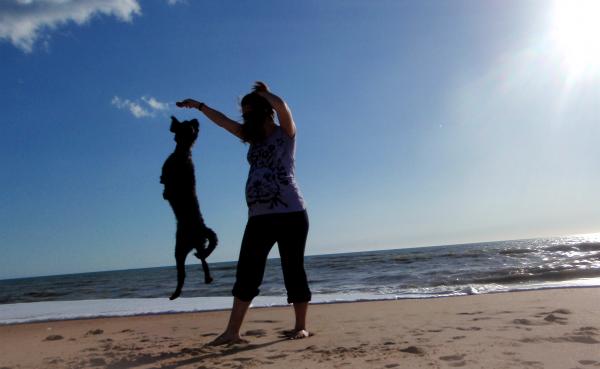 Pregnant woman playing with her dog