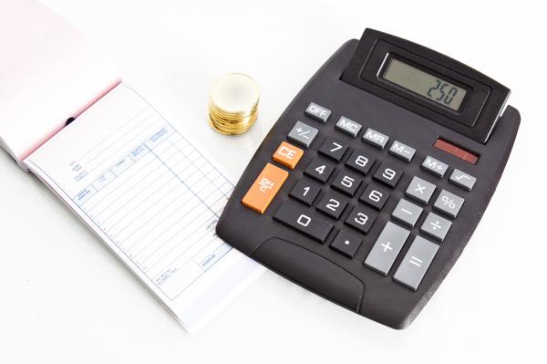 Receipt book with calculator and coins