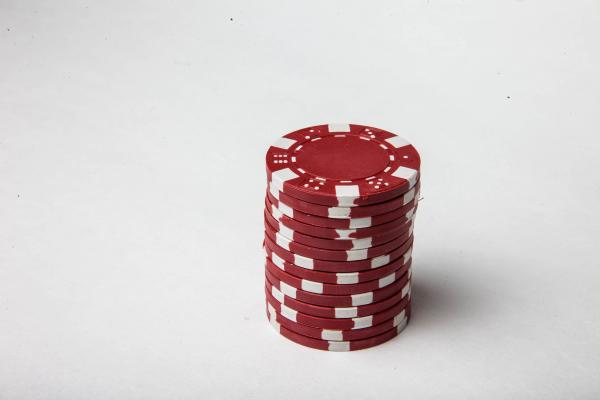 Red poker chips on white background