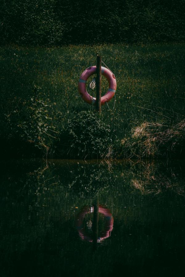 Red Wooden Float on Swamp