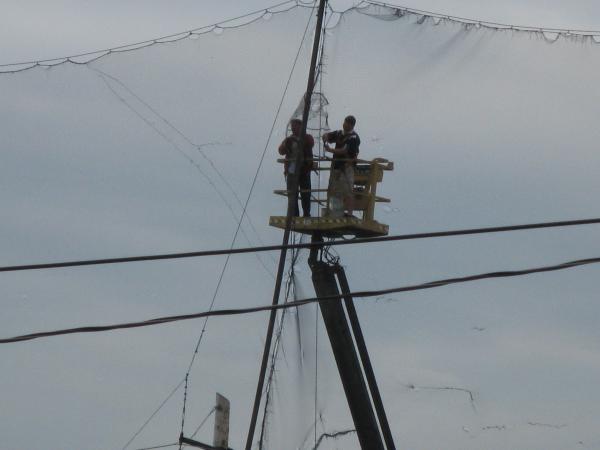 Repairing a net at a golf driving range -d.jpg
