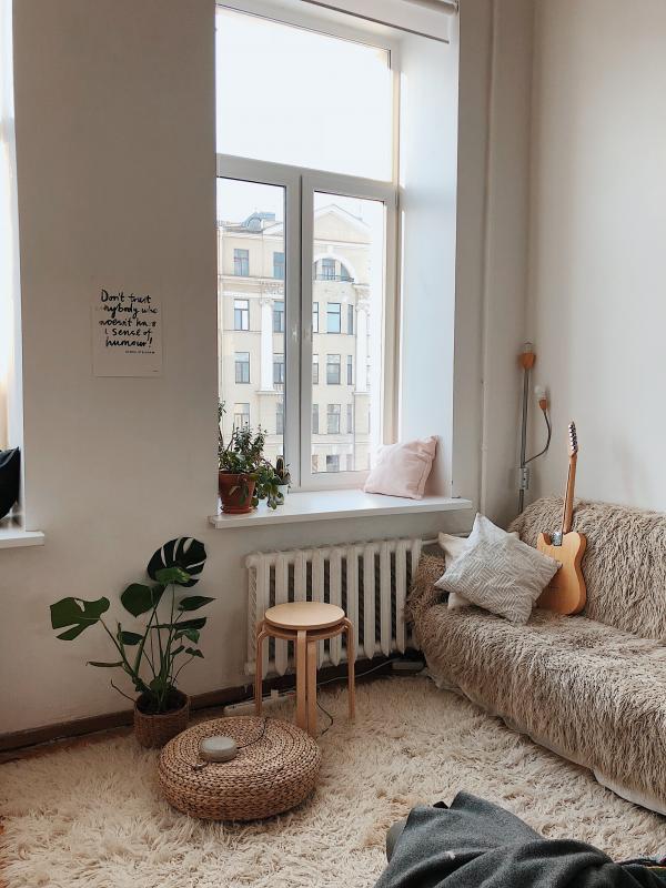 Round Brown Wooden Stool Near Brown Sofa