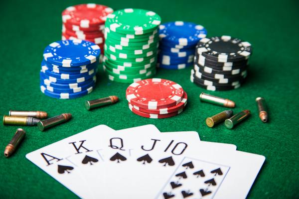 Royal Flush with bullets and poker chips