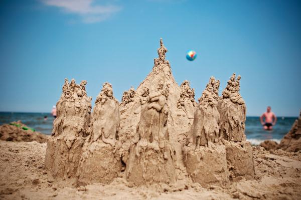 Sand Sculpture on Beach Under Blue Sky