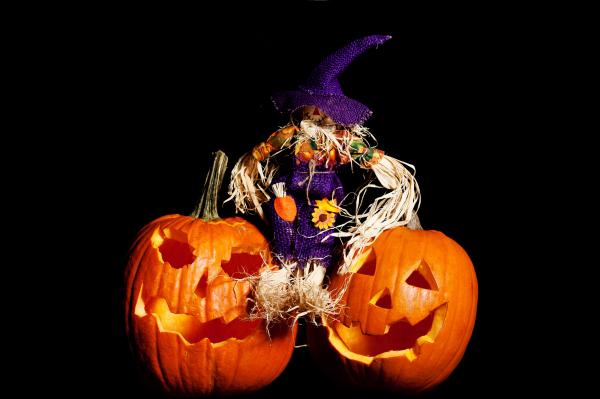 Scarecrow sitting on Pumpkins