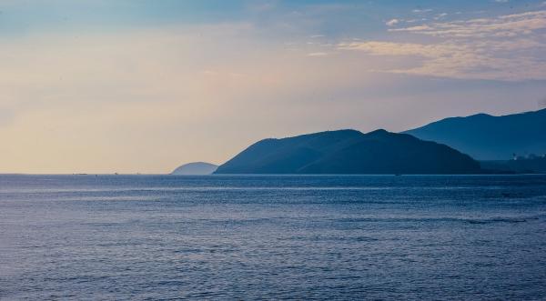 Scenic View of Mountains Near Ocean