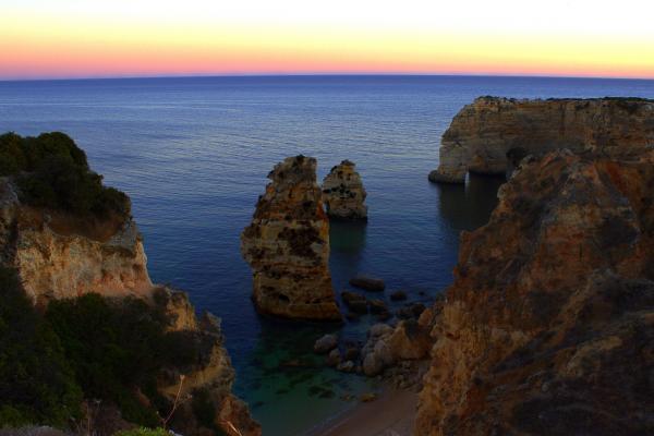 Sea stacks and sandstone cliffs at dusk