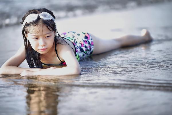 Selective Color Photography of Girl Lying on Beach