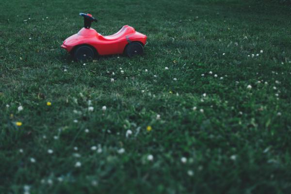 Selective Focus Photography of Red Ride on Toy