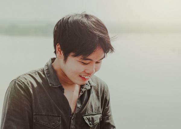 Selective Photography of Smiling Man Wearing Black Button-up Collared Top