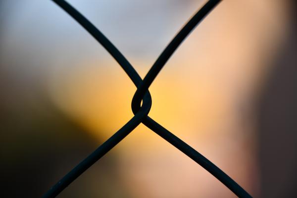 Shallow Focus Photography of Silhouette of Cyclone Wire