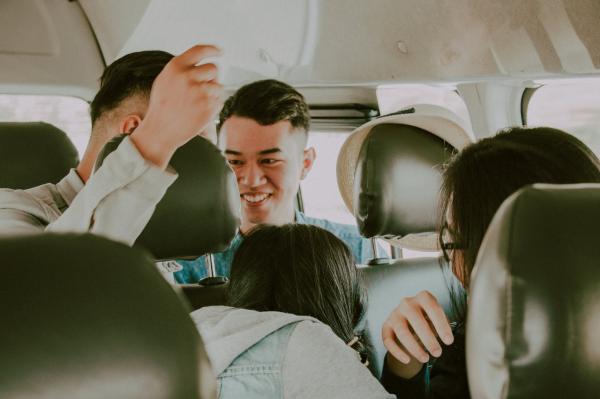 Shallow Photography of Man in Green Top Inside Vehicle
